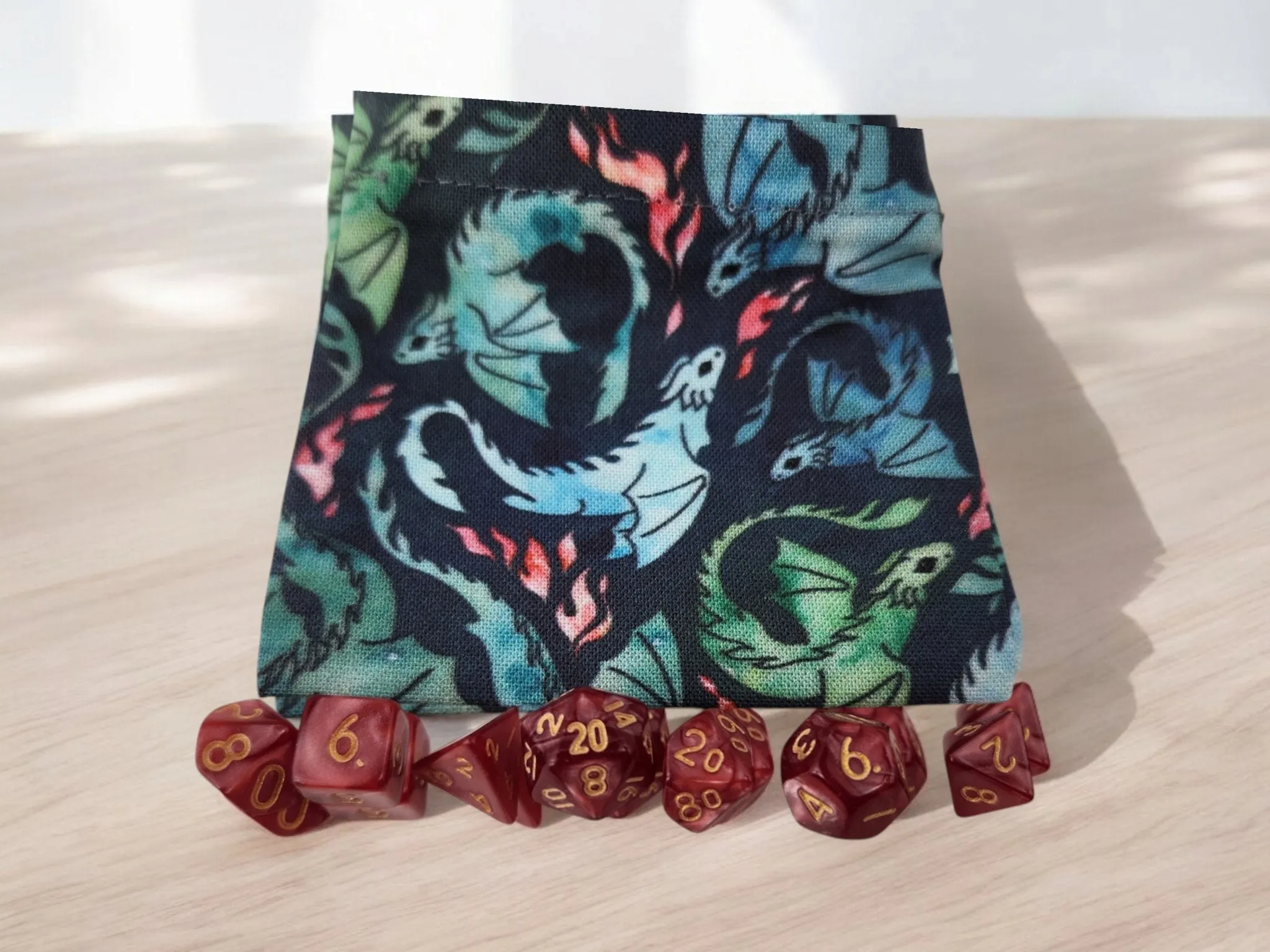 Mini dragon drawstring bag with a set of mini dice, dark red dice